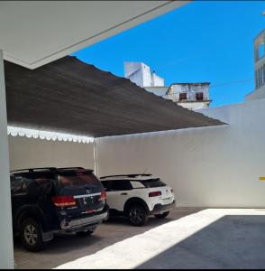 two cars are parked in a garage at Confort Platense departamento con cochera in La Plata