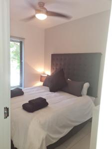 a bedroom with a large bed with two pillows on it at The Bridge UNIT 23 St Lucia in St Lucia