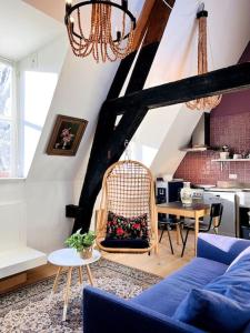 uma sala de estar com um sofá azul e uma mesa em Gloria's loft op de Grote Markt em Breda