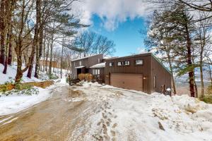 a house with a garage in the snow at Amazing View Retreat Home in Campton