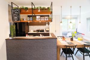 a kitchen with a counter and a table with chairs at TEINE WHITE HOUSE in Sapporo