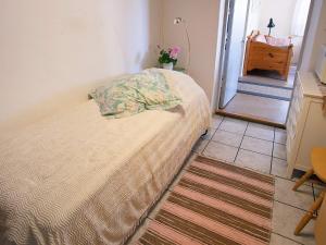 a bedroom with a bed with a pillow on it at Holiday home in Hamburgsund 2 in Gerlesborg