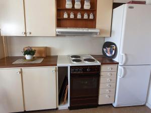 a kitchen with a stove and a refrigerator at Holiday home in Hamburgsund 2 in Gerlesborg
