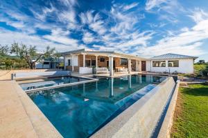 a swimming pool in the backyard of a house at Villa Sara in Lotzorai