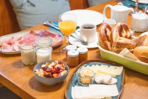 a table topped with a tray of food and bread at Gasthaus zum Schwan in Castell