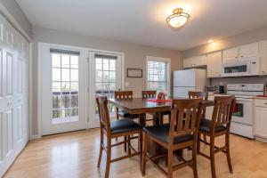 a kitchen and dining room with a table and chairs at Hoosier Happiness, Too! 3 Bedroom Suites Near IU & Downtown in Bloomington
