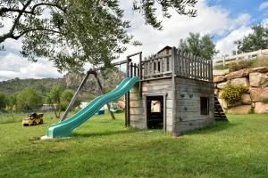 a playground with a slide in the grass at Villa Sara in Lotzorai