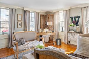 a living room with a chair and a table at The Watson Boutique Bed and Breakfast in Thompson