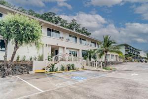 a large white building with a parking lot at Unit 12 Maui Ohana Modern Studio in Wailuku