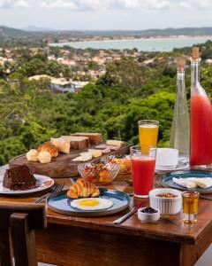 einen Tisch mit Frühstückszutaten und Getränken darauf in der Unterkunft O HOTEL in Búzios