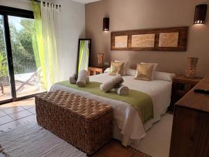 a bedroom with a bed and a large window at Sa Bardella in Sant Joan de Labritja