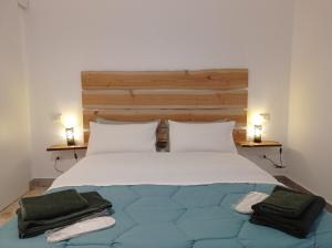 a bedroom with a large bed with two towels on it at CasaRA in Bari