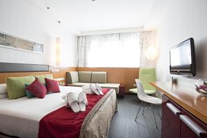TV a/nebo společenská místnost v ubytování Novotel Roma Eur