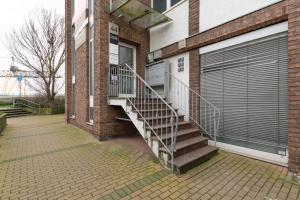 a staircase leading to a building with a garage at T&K Apartments - 3 - 5 Group Room Apartments- 15min to Fair DUS in Neuss