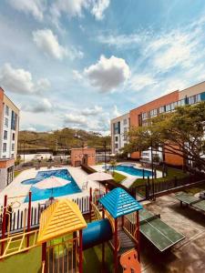 - une vue sur une aire de jeux avec 2 piscines dans l'établissement Elegante apartamento, à Cartago