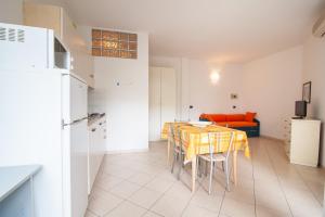 a kitchen and dining room with a table and chairs at APPARTAMENTI SIVIGLIA in Cattolica