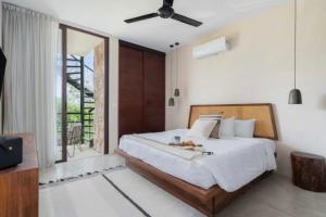 En eller flere senge i et værelse på Apartamento Vacacional Tulum Quintana Roo Mexico