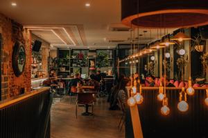 a restaurant with people sitting at a bar at The Camden Town Hotel in London