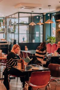 two women sitting at a table in a restaurant at The Camden Town Hotel in London