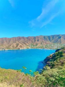 a view of a blue lake with mountains in the background at Taganga Dive Inn in Taganga