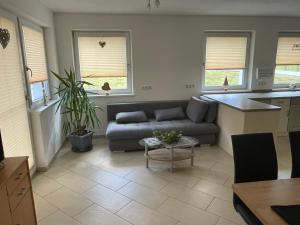 a living room with a couch and a table at Karo`s Apartment in Mittersill