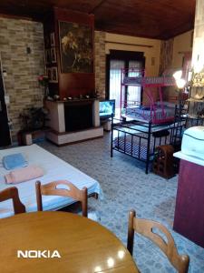 a room with two beds and a table and chairs at Alex house with garden in kallithea halkidiki in Kallithea Halkidikis
