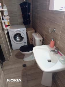 a small bathroom with a toilet and a sink at Alex house with garden in kallithea halkidiki in Kallithea Halkidikis