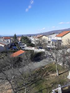 a view of a town with houses and trees at Apartman Bonaca in Jadranovo