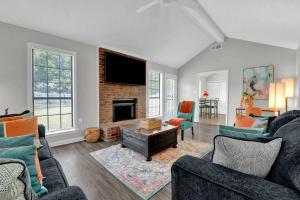 a living room with a couch and a fireplace at Glamorous 3BR 2BA house w/ large fenced backyard in Memphis