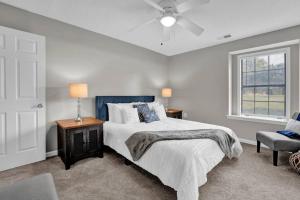 a bedroom with a bed and a ceiling fan at Glamorous 3BR 2BA house w/ large fenced backyard in Memphis