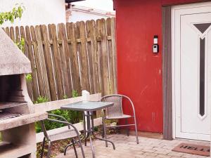 een tafel en stoelen op een patio naast een hek bij Schönes Apartment in Niebüll in Niebüll