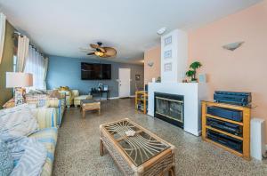 a living room with a couch and a fireplace at Sunset Beach House in Clearwater Beach