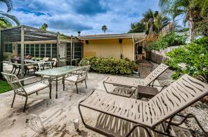 a patio with a table and chairs and a house at Sunset Beach House in Clearwater Beach