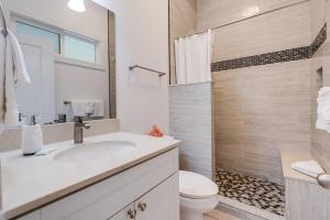 a bathroom with a sink and a toilet and a shower at Unit 14 Maui Ohana Modern Studio in Wailuku