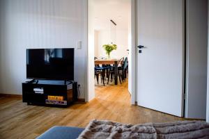 a living room with a television and a table with chairs at Ferienhaus Regenstein in Winterberg