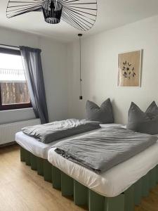 ein großes Bett in einem Zimmer mit Fenster in der Unterkunft Ferienhaus Regenstein in Winterberg