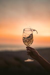a hand holding a wine glass with water in it at Puerto Bianco Private Residence Collection in Copala