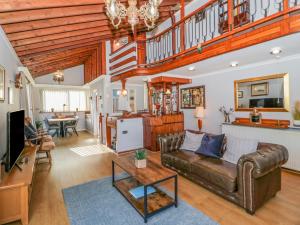 a living room with a couch and a table at Boathouse in Deganwy