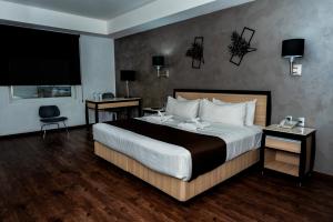 Postel nebo postele na pokoji v ubytování Fato Hotel