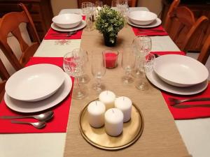 una mesa con platos y vasos y velas en CasaPepi, 5 minutos Parque Puy du Fou, en Guadamur