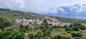 a town on top of a hill near the ocean at Casa rural meridiano in El Pinar del Hierro