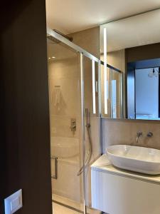 a bathroom with a sink and a shower with a tub at Riva 14 in Lugano