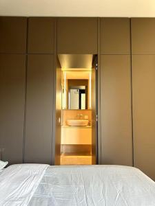 a bedroom with a bed and a bathroom with a sink at Riva 14 in Lugano