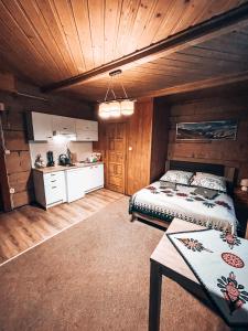 a bedroom with a bed and a table in it at Willa Pod Stokiem in Zakopane