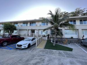 a white car parked in front of a building at Unit 19 Maui Ohana Modern Studio in Wailuku