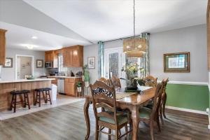 a kitchen and dining room with a wooden table and chairs at The Greenhouse in the Heart of Midlothian in Midlothian