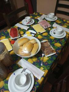 uma mesa com um prato de pão e pratos de comida em Casa da Lu em Olinda