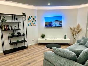 a living room with a couch and a table at Apartment Klabautermann in Neubukow