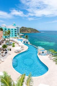 an aerial view of a resort swimming pool and the ocean at Oyster Bay Beach Resort in Dawn Beach