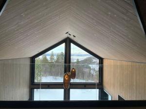 a large window in a room with a view of the snow at Høy standard med nydelig utsikt in Alta